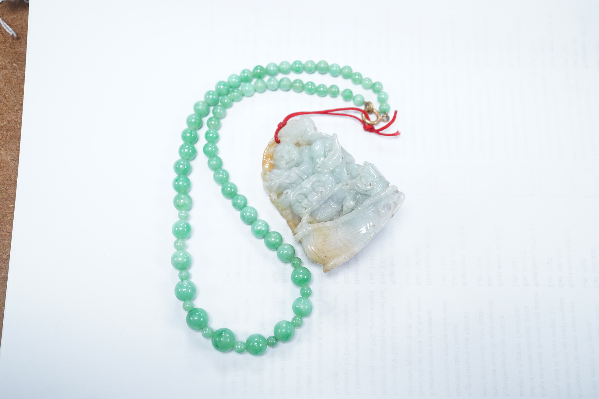 A Chinese jadeite carving and jadeite bead necklace, carving 6.5cm long. Condition - good